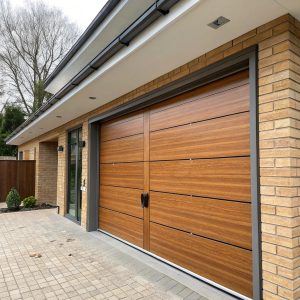 Sectional garage door with four horizontal panels in mid-operation, showing tracks guiding panels along ceiling of a contemporary suburban home.