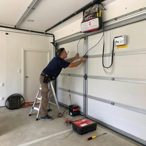 A garage door being atendend to by a technician